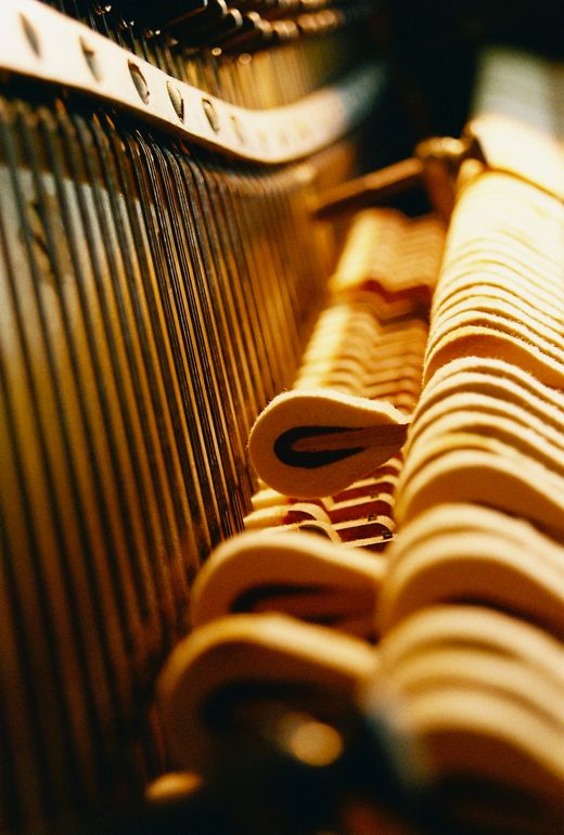 An artsy close-up of the action of an upright piano